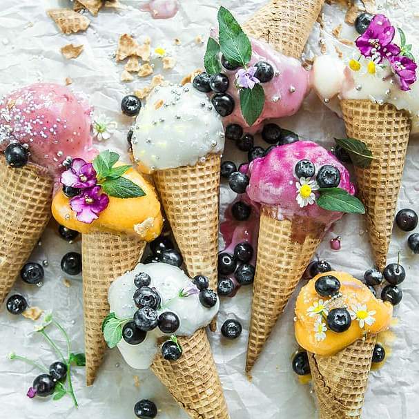 lots of decorated ice creams on table