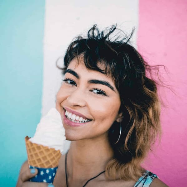 girl's smile with ice-cream in hand